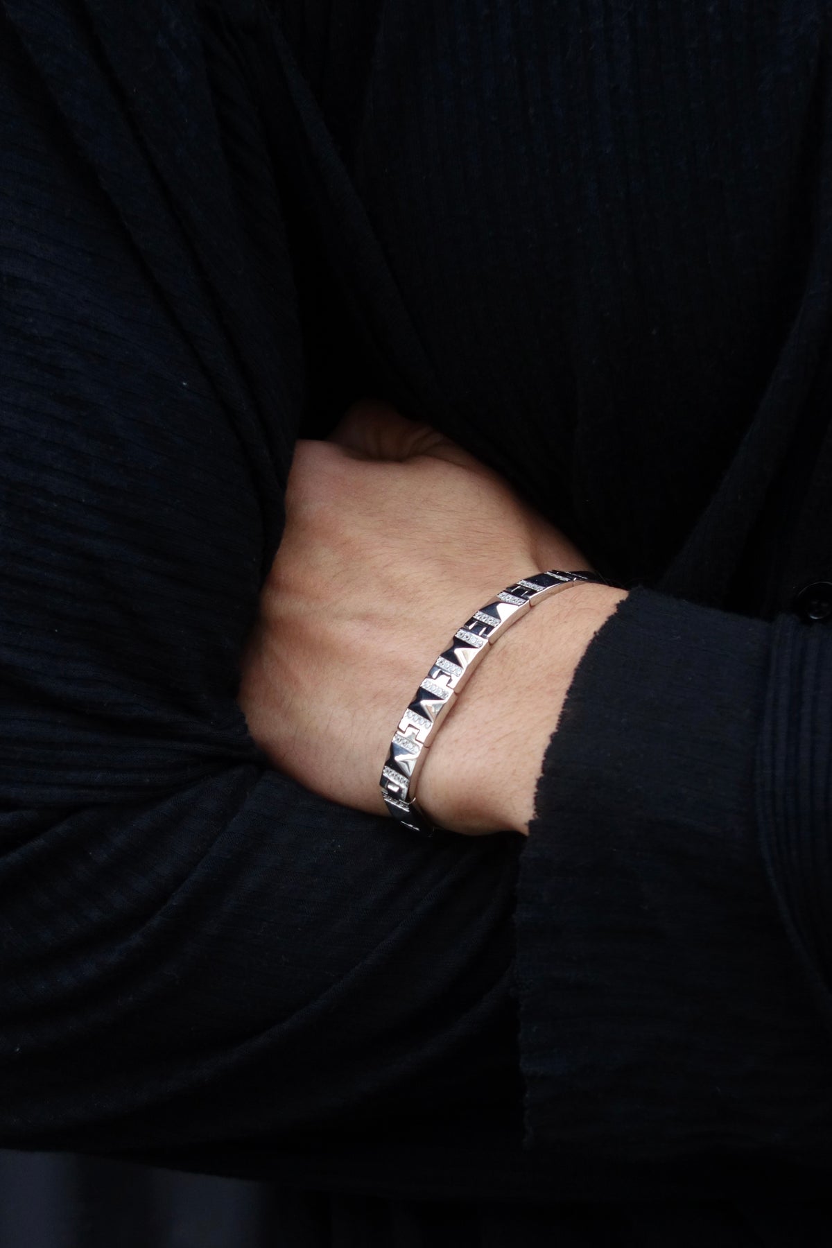 Frosted Grid Bracelet worn on the wrist below a black sleeve