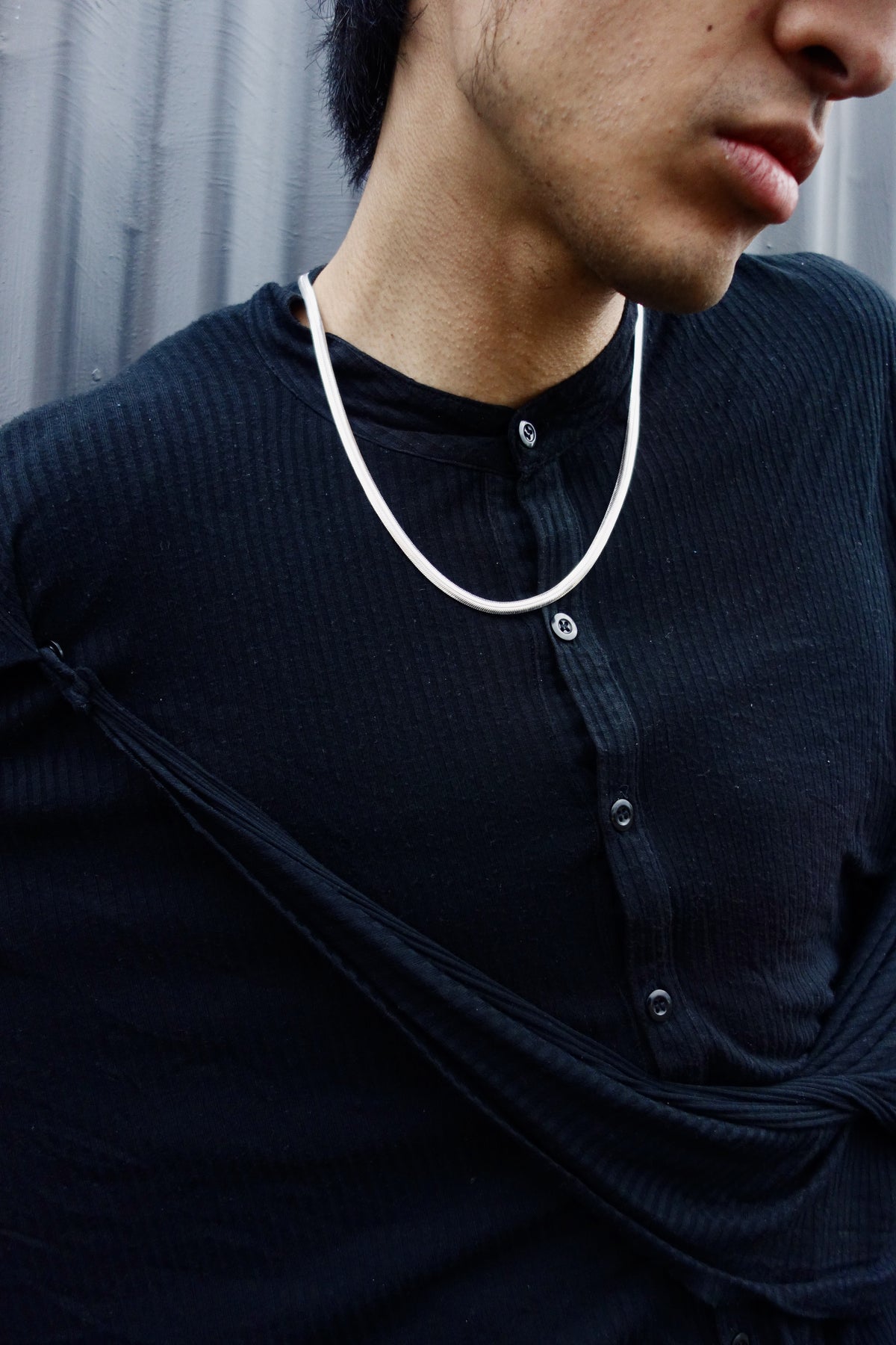 Mamba Chain worn at the collarbone over a black shirt